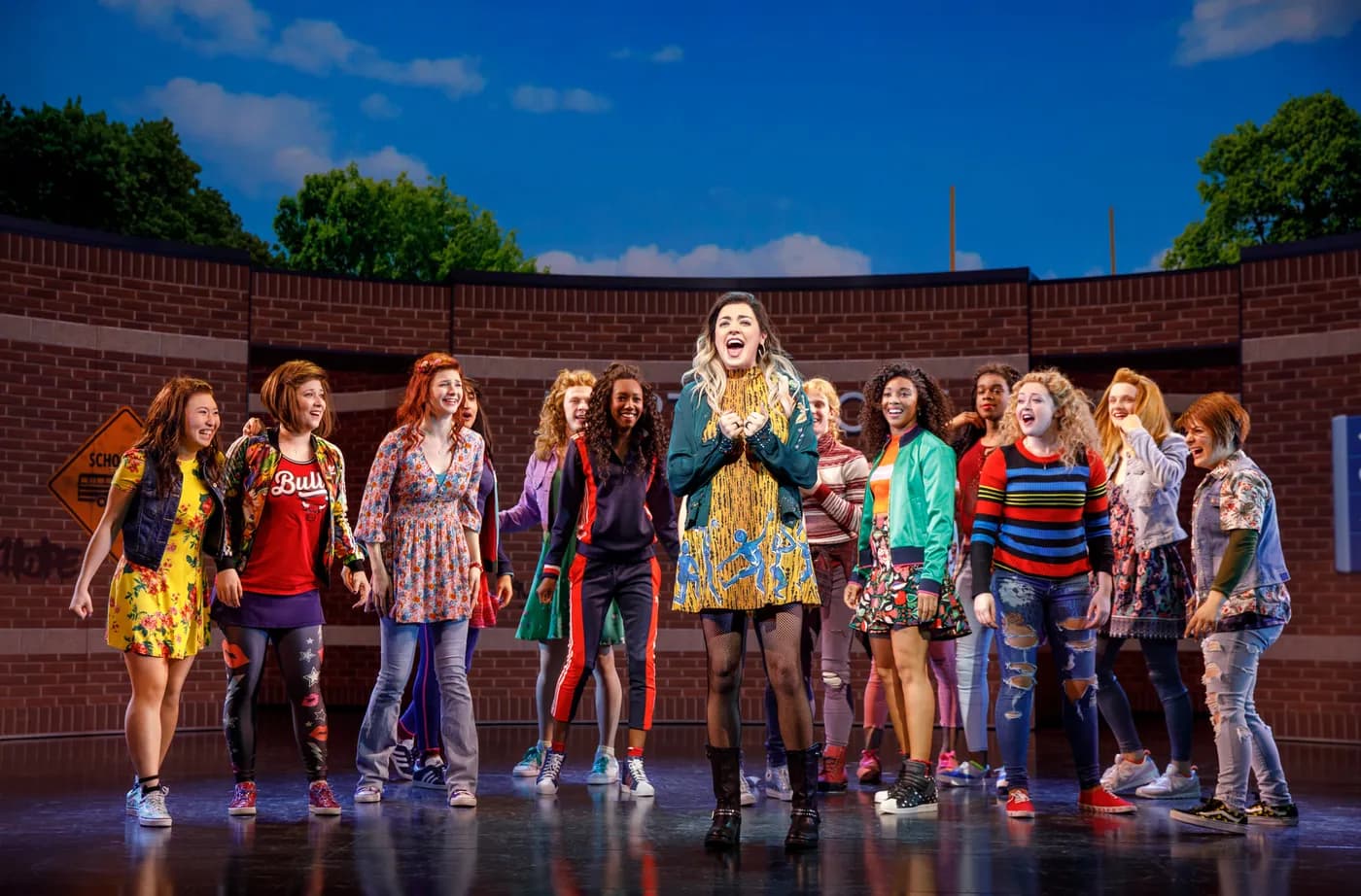  Janis rallies classmates in an outdoor scene, framed by FRAY Studio’s sunny schoolyard backdrop.
