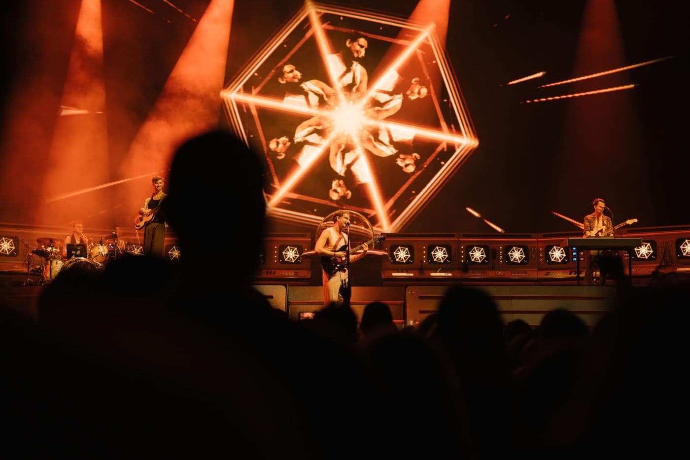 Glass Animals performing live with FRAY Studio visuals on hexagonal screen  
