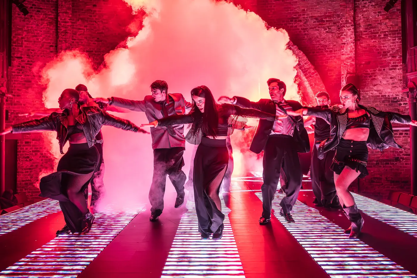Cool young people dance in a club scene on stage in American Psycho at the Almeida Theatre