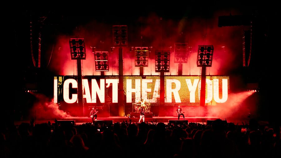 Image showing the words "I can't hear you" large across the stage on Pierce the Veils 2025 concert tour